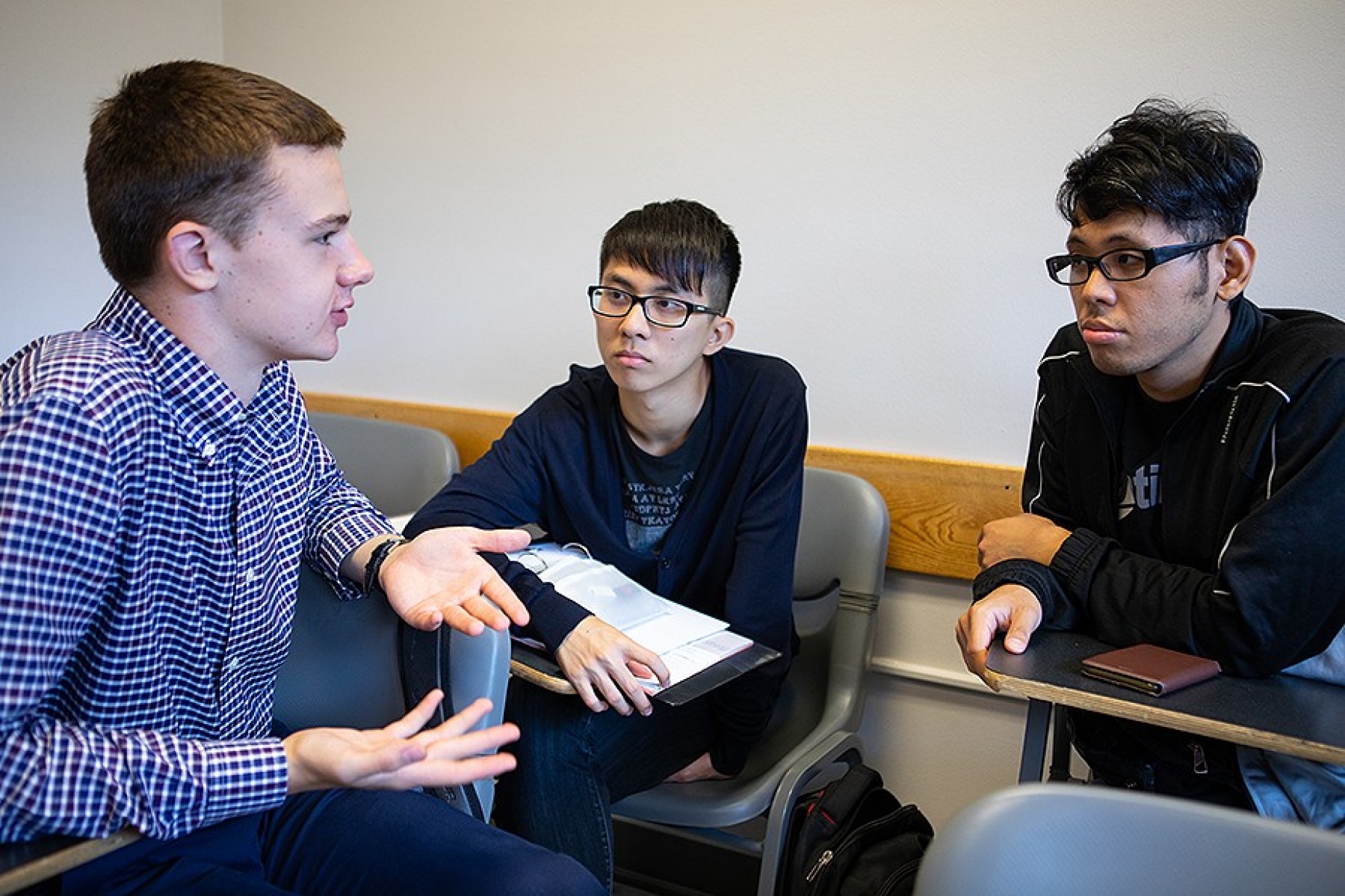 From left, Krzyszstof Sobieraj, Tsz Ho Kiang and Francis Poon speak together during UB’s Intensive English Program.