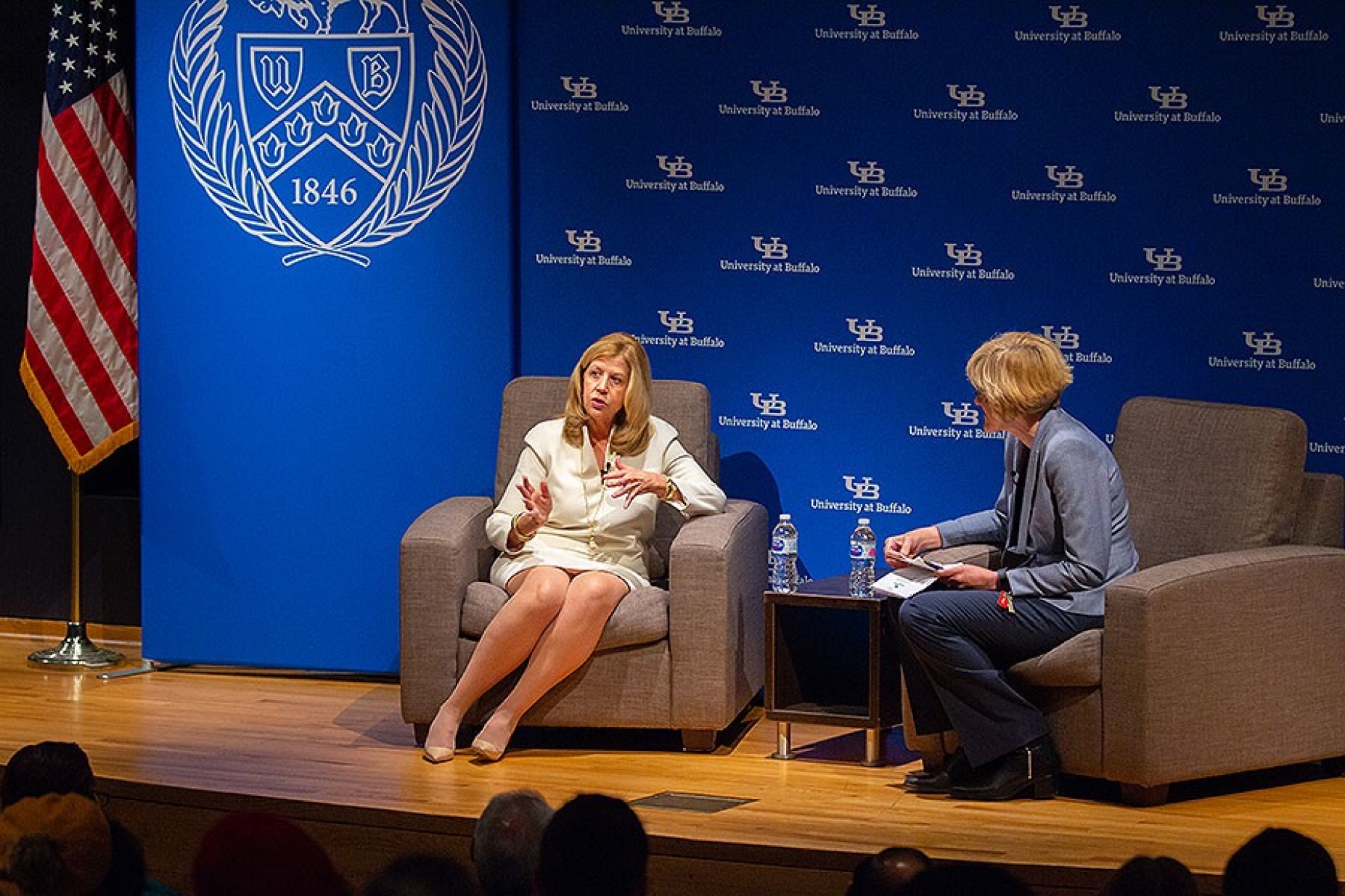 Abbe Rave seated onstage, during her conversation with Robin G. Schulze, dean of the College of Arts and Sciences.