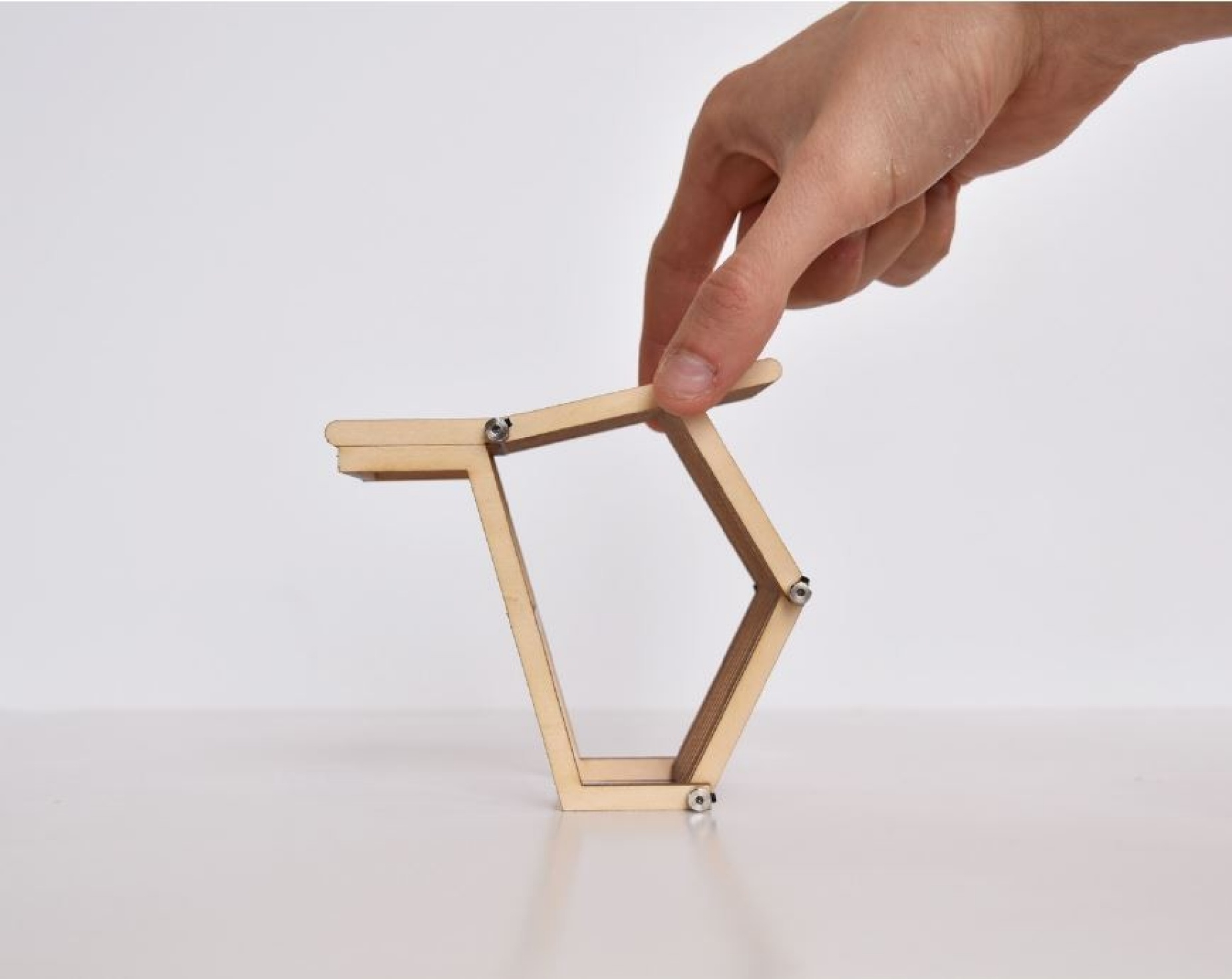 Hand manipulating model of transforming bench concept. 