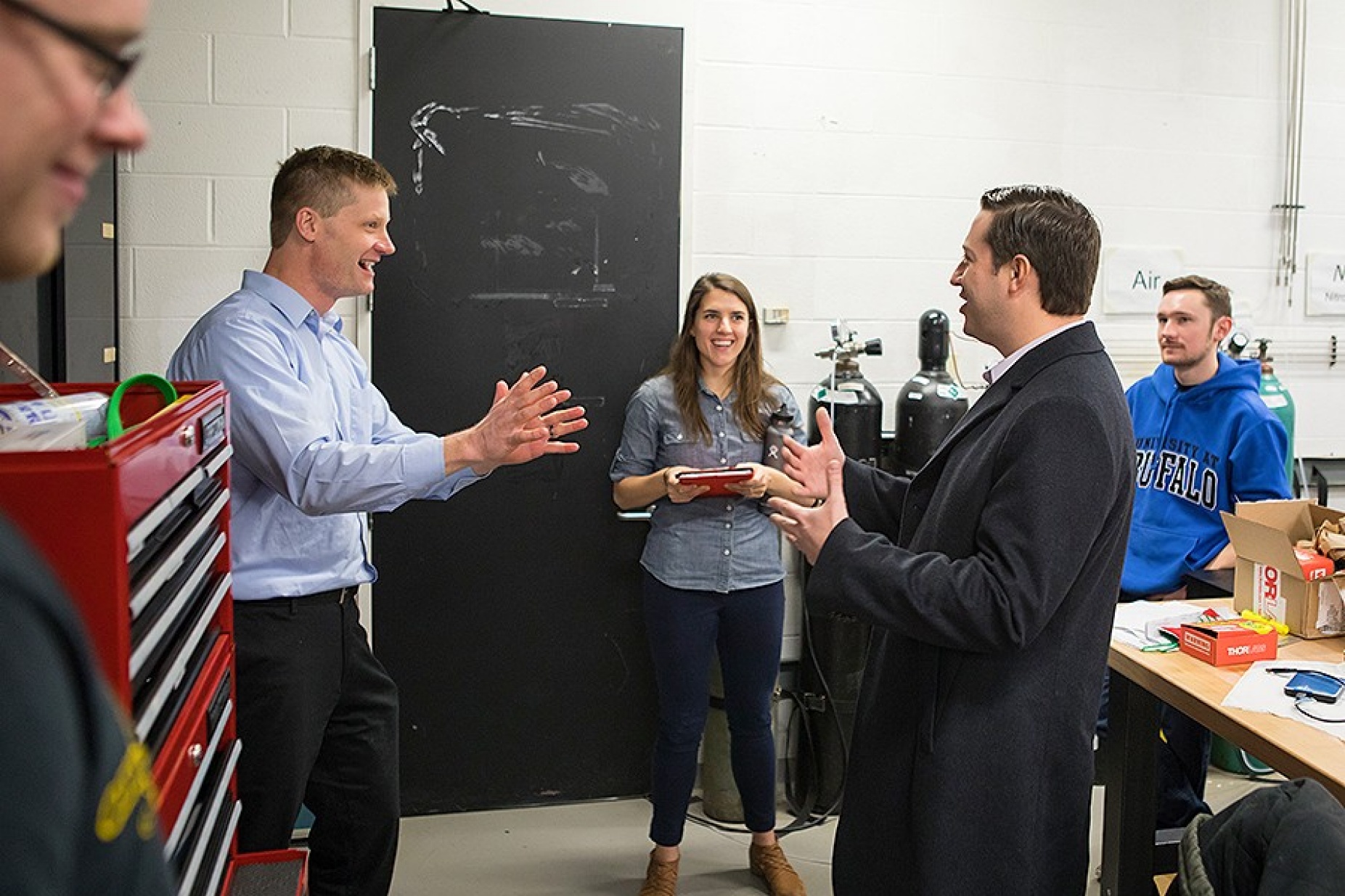 Bradley Cheetham reminisces with professor Paul DesJardin during his stop at the Combustion and Energy Transport (CET) Laboratory. 