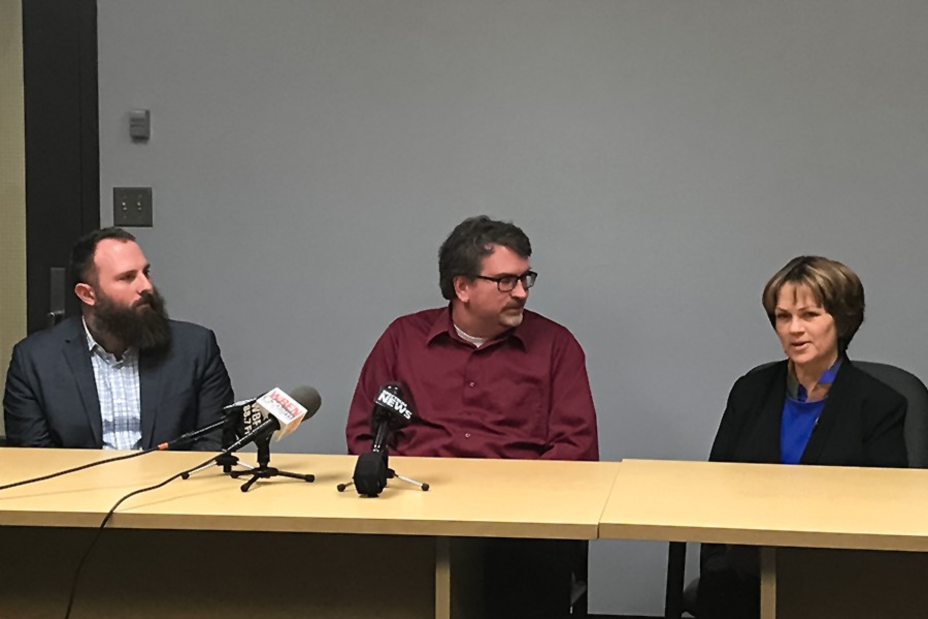From left, Jacob Neiheisel, associate professor of political science, and James Battista, associate professor of political science listen as Kari Winter, professor of American studies shares her thoughts on the midterm elections with local media. 