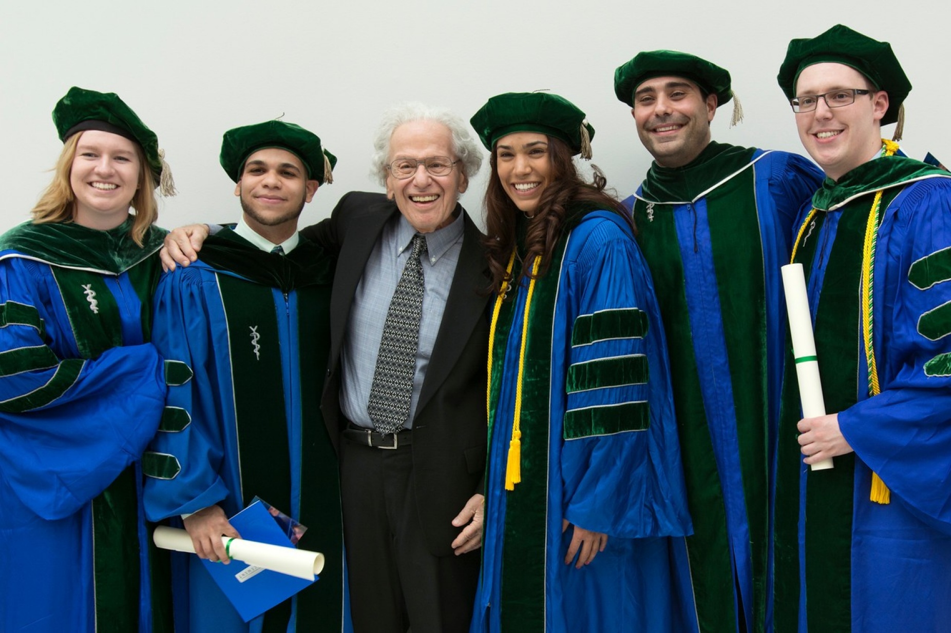 Murray Ettinger surrounded by medical school graduates. 