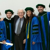Murray Ettinger surrounded by medical school graduates. 