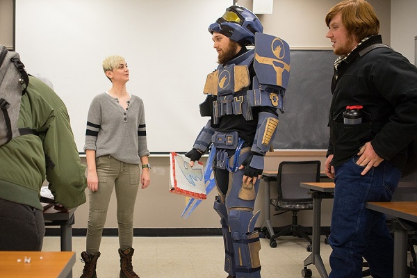 Zoom image: Stephanie Phillips talks with student Shane Landman, who wore his handmade costume to class. Photo: Douglas Levere 