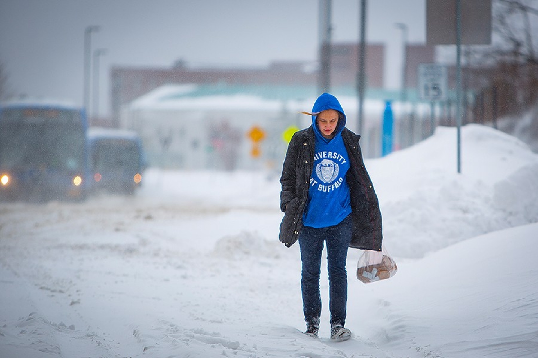 Students walking in a snowstorm. 