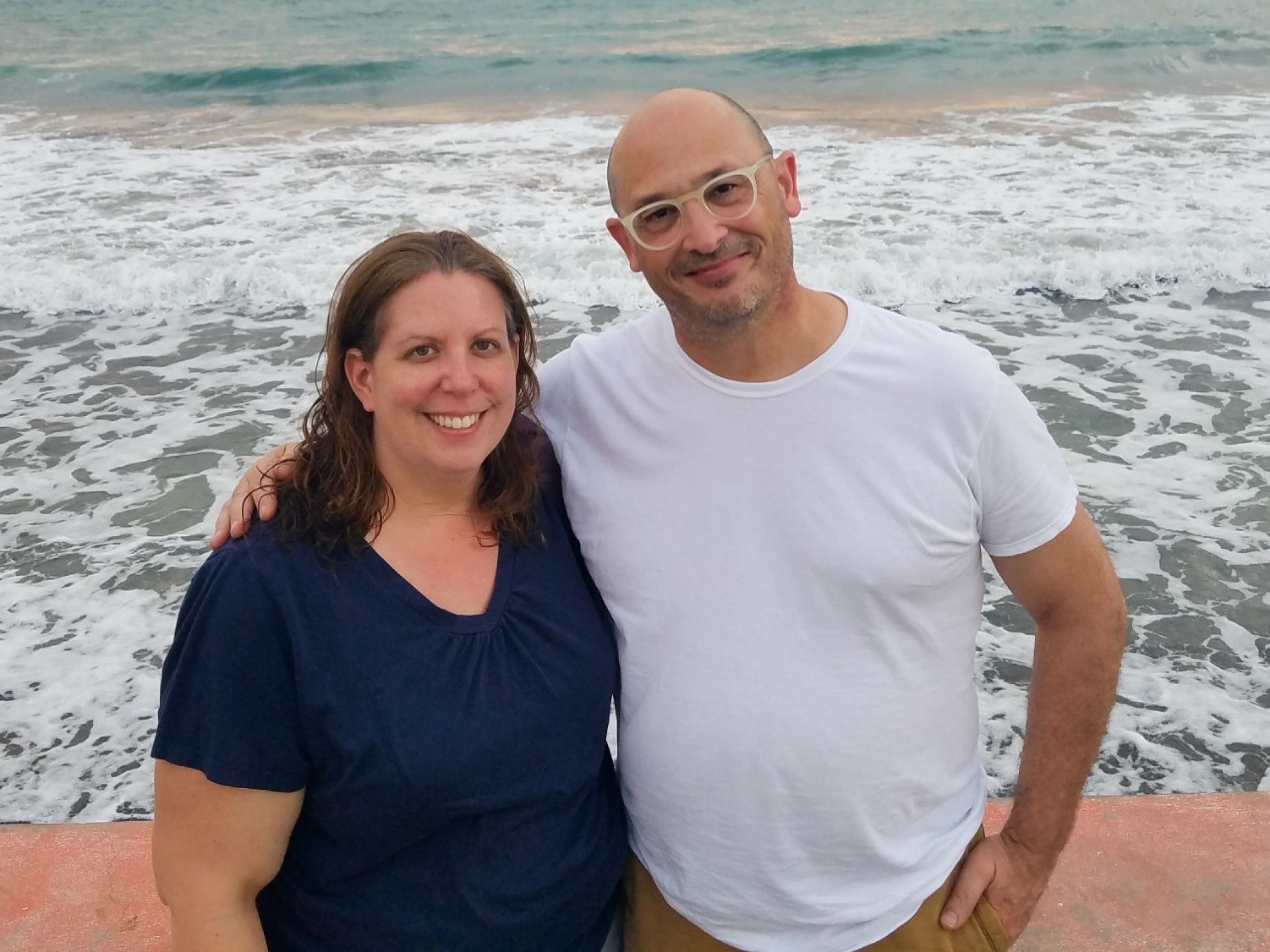 Kim Persons and Dave Merlo pose at a beach in haiti. 