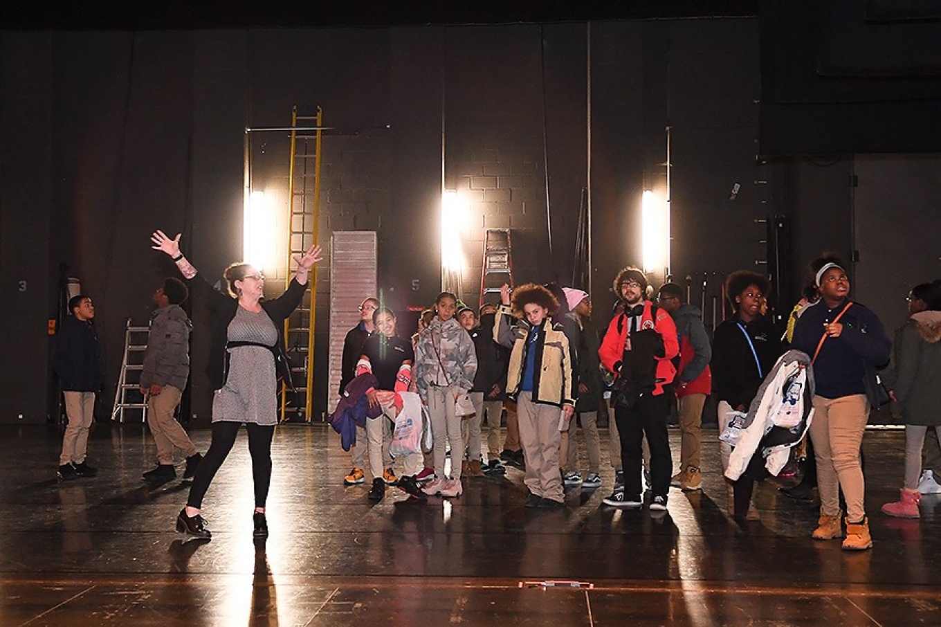 Moriah Bolinsky Hegmann led the eighth graders on a tour through Screening Room, and Mainstage Theater, where she brought them onto the stage.
