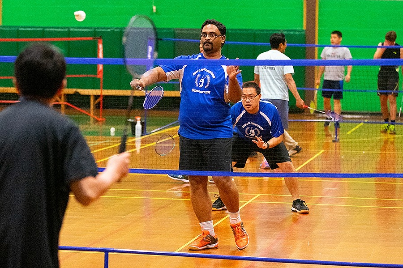 (Center and right) Praveen Arany, assistant professor in the UB School of Dental Medicine, and Daniel Chan, an engineer with OptiMed Technology, on the court during a match at Rally Niagara Badminton.