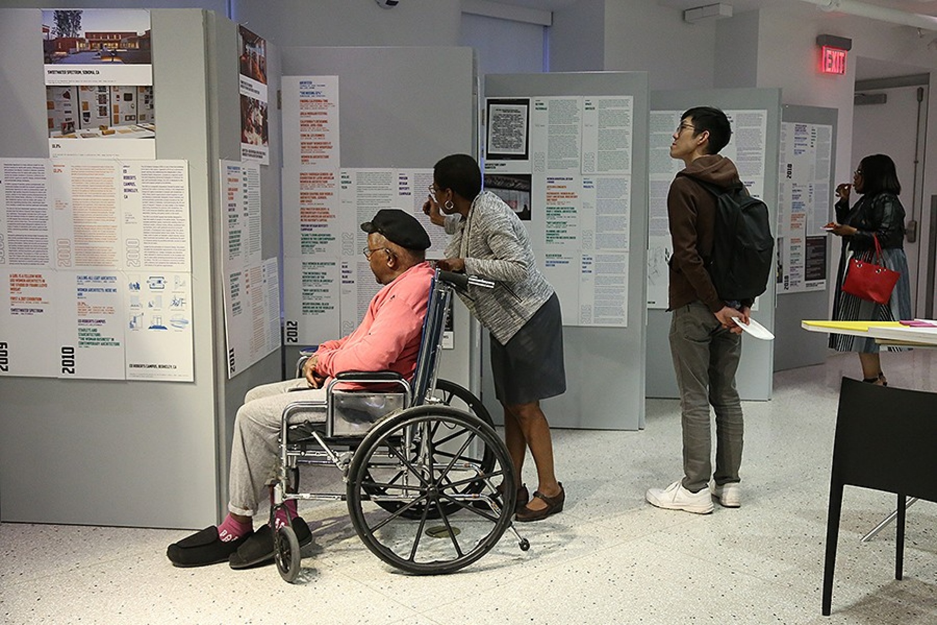 Community members examine the "Now What?!" displays. 