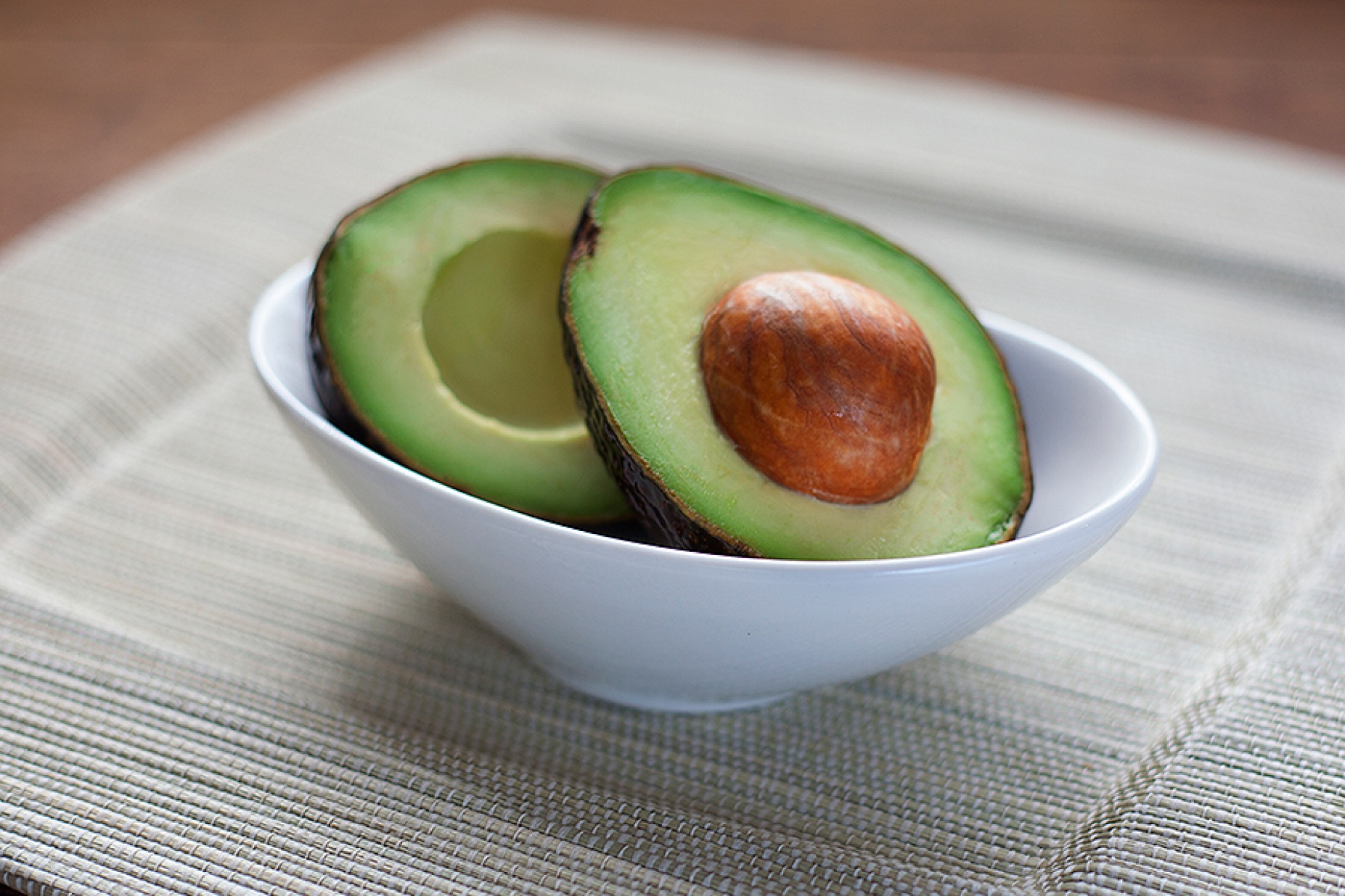 Bowl with a cut avocado. 