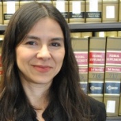 Samantha Barbas photographed in front of a shelf of law books. 