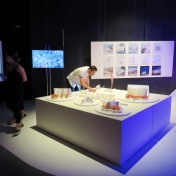 MArch student Zach Fields makes last-minute final touches to Hwang's Hidden in Plain Sight concept models at the "Cyborg Garden, Mutant Institute of Environmental Narratives" exhibition in Matadero Madrid. 