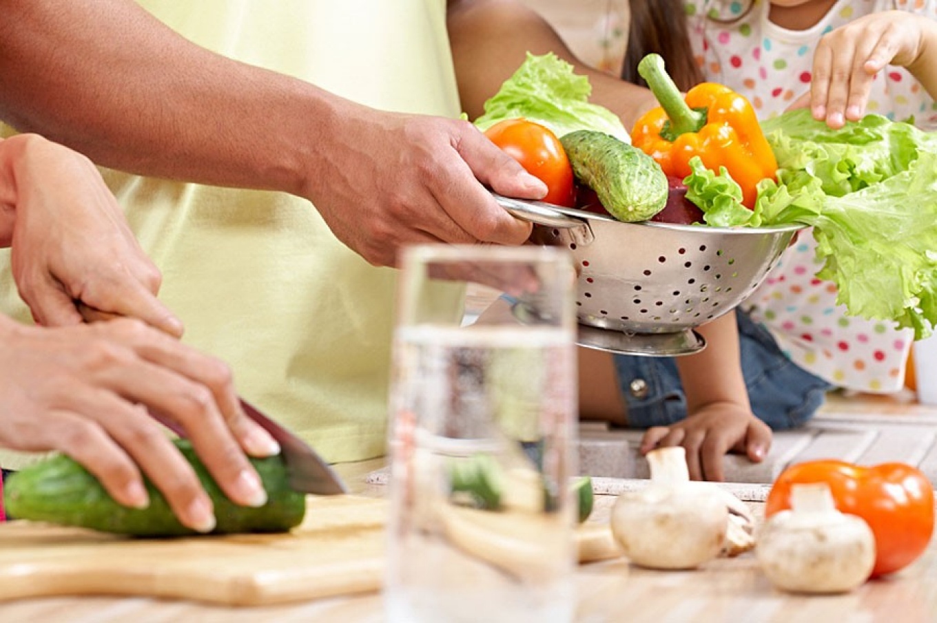 preparing food with colander full of vegetables. 