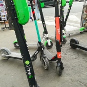 Shared scooters on a sidewalk in France. 