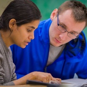 Teaching assistant helping a student. 