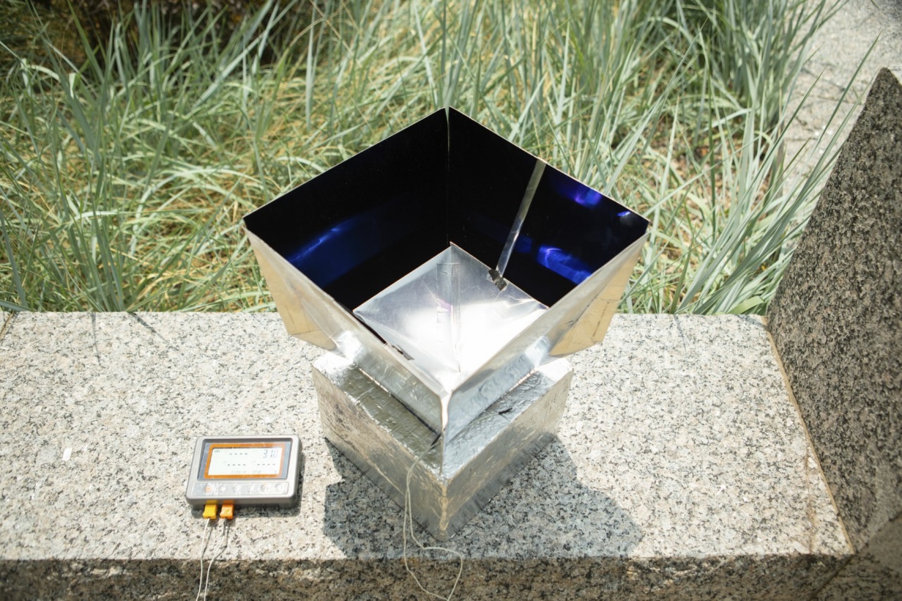 The system helps cool its surroundings by absorbing heat from the air inside the box and transmitting that energy through the Earth’s atmosphere into outer space. Credit: University at Buffalo.