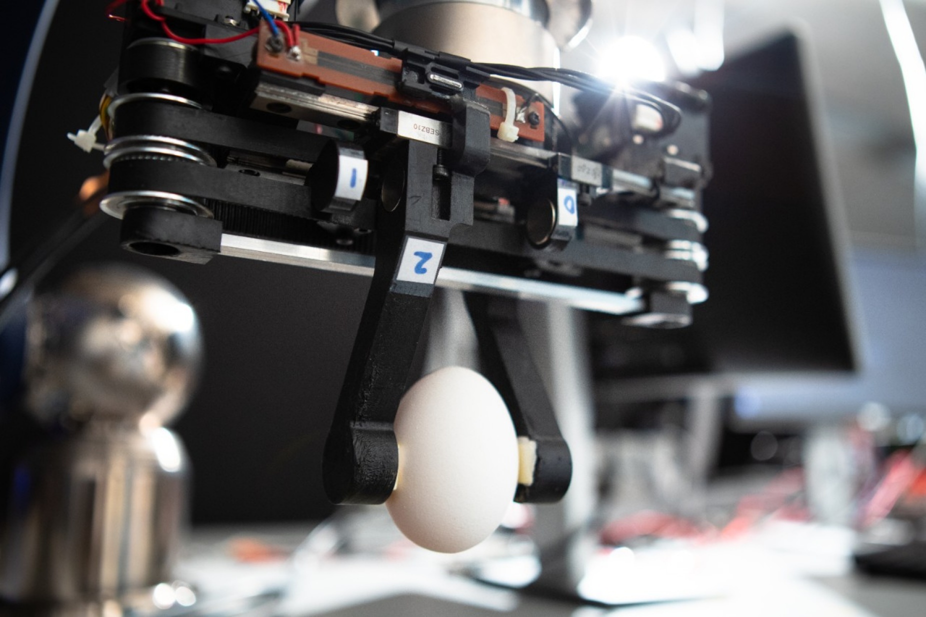 Zoom image: A robotic gripper developed in the lab of University at Buffalo engineer Ehsan Esfahani uses repulsion between magnets to adjust the stiffness of its grip, improving safety. Photo: Douglas Levere 