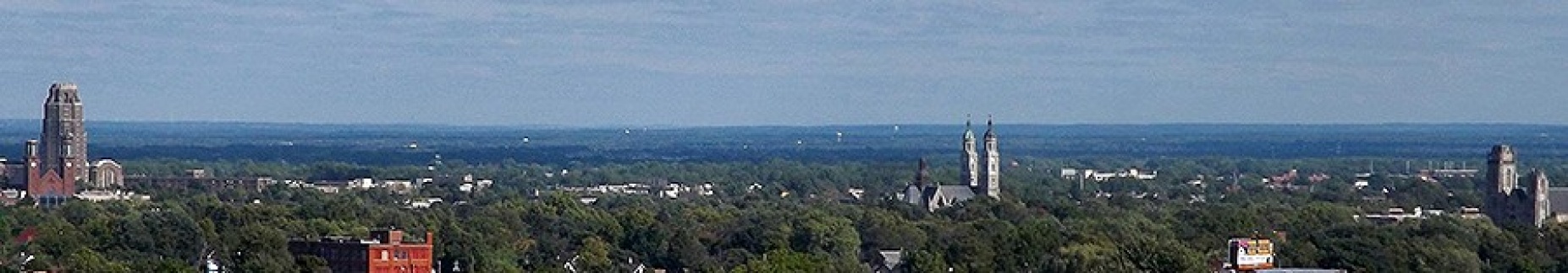 Zoom image: A panoramic skyline view of the East Side of Buffalo — and its myriad of churches — as seen from top of the parking ramp at Roswell Park Comprehensive Cancer Center. Photo: Andre Carrotflower CC BY-NC-SA 