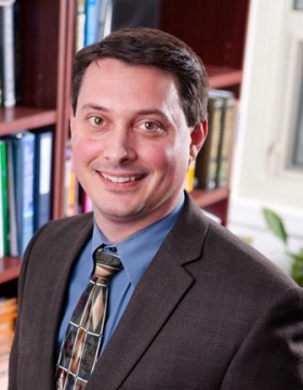 Portrait of UB researcher Greg Homish in his office. 