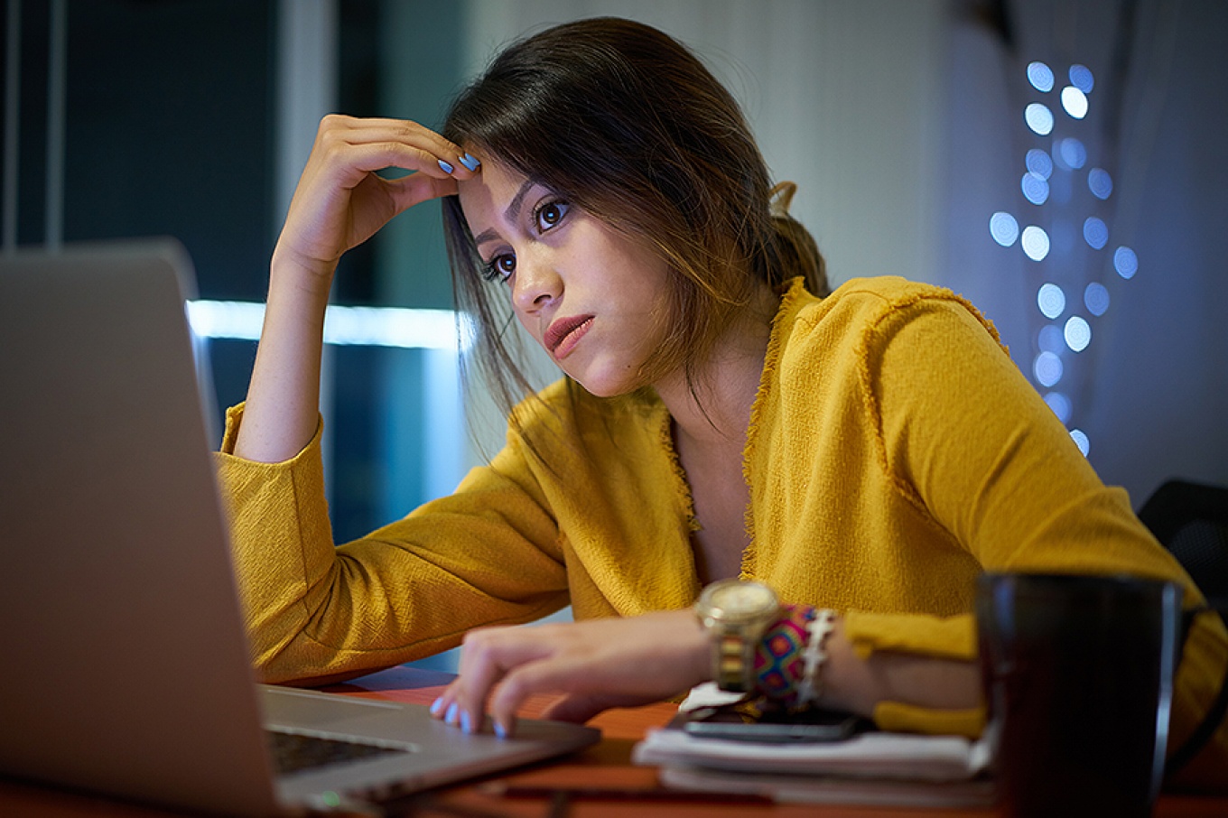 Pensive female college student studying at night.