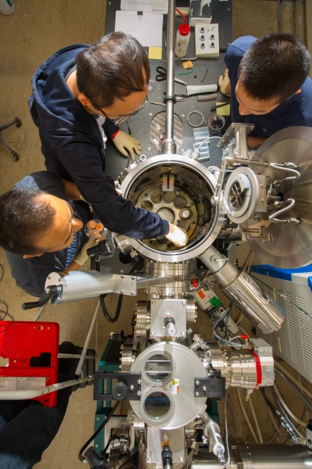 Zoom image: UB researchers work with a dual-chamber thin film deposition system that can be used to synthesize thin film materials. In the new study, this machine was used to create europium sulfide films and tungsten trioxide, a precursor for 2D tungsten disulfide. Photo: Douglas Levere 