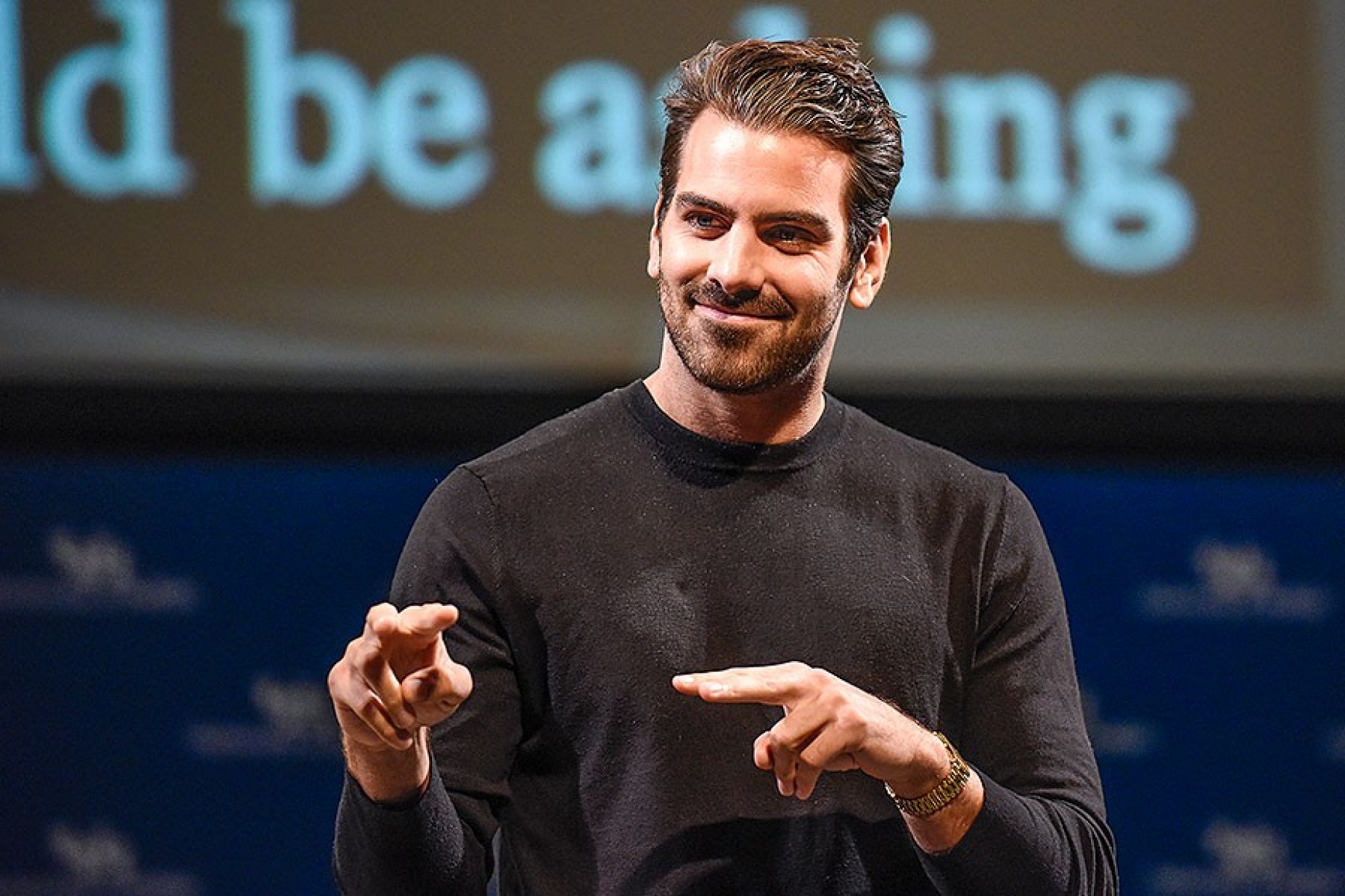 Nyle DiMarco signing during his Distinguished Speakers Series appearance. 