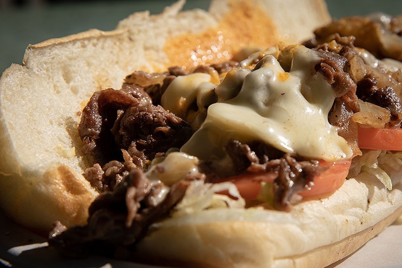 Zoom image: The steak hoagie at Sizzles features Angus beef, sauteed onions, white cheddar cheese, lettuce, tomato and a special sauce. Photo: Meredith Forrest Kulwicki 
