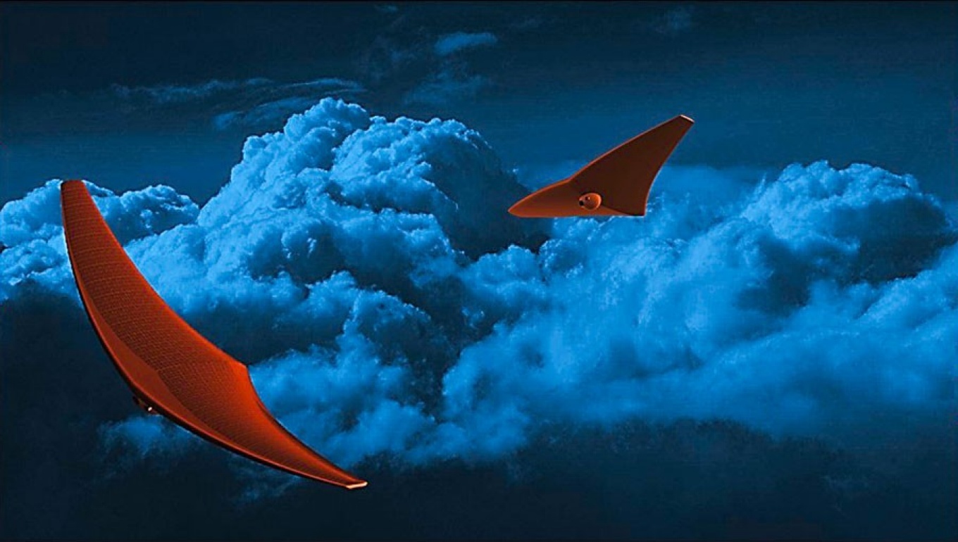 A rendering of two stingray-like BREEZE spacecraft exploring the atmosphere of Venus, which is depicted by dark blue clouds. 