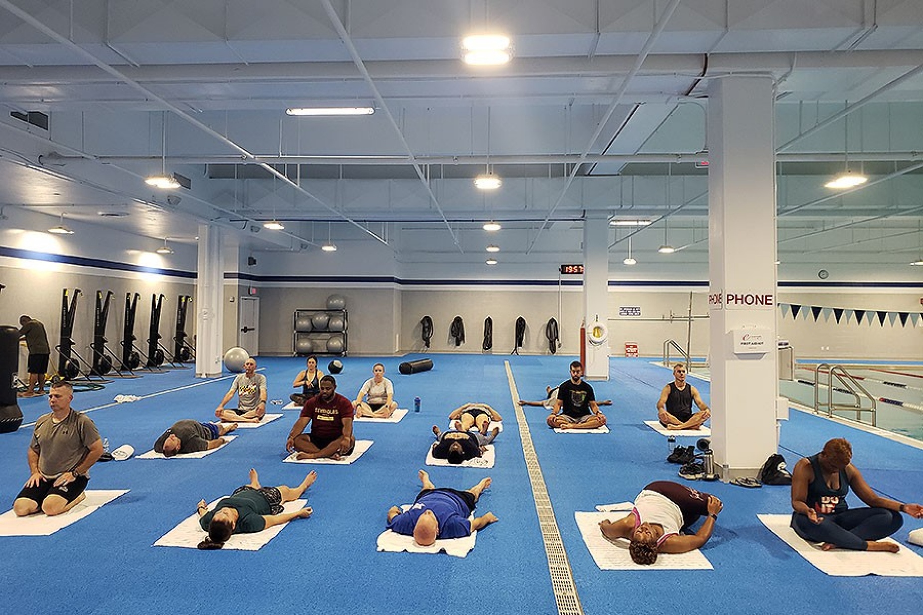 Zoom image: A certified yoga instructor, Stacy Tuberdyke leads a class for members of law enforcement agencies attending the National Academy. With no yoga studio inside Quantico, classes were held on the pool deck. Photo: Courtesy of Stacy Tuberdyke 