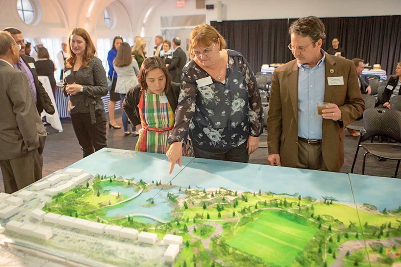 Members of the public look at a model of Ralph C. Wilson Jr. Centennial Park.