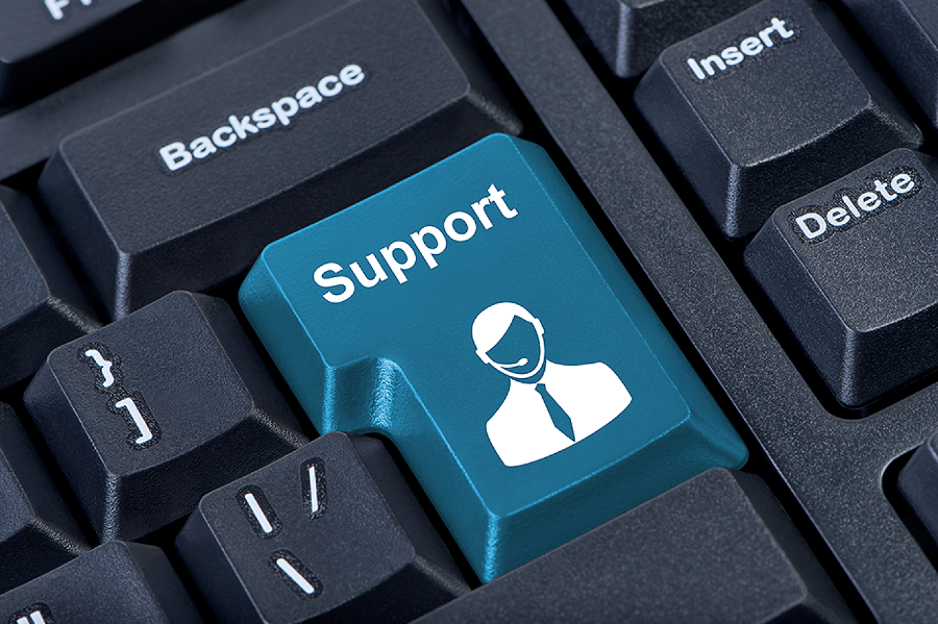 Computer keypad with an IT support icon. 