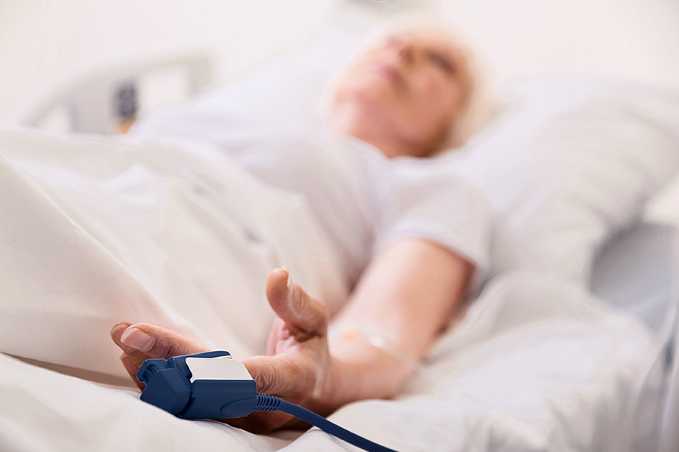 Hospital patient pictured with a pulse oximeter on their finger. 