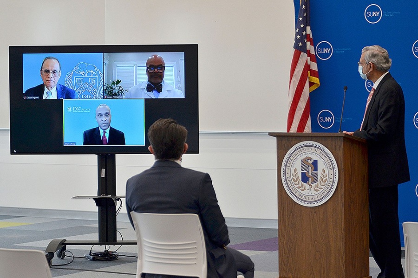 UB President Satish K. Tripathi on a monitor with the presidents of two other SUNY medical schools at an announcement of the new SUNY Pre-OP program at Upstate Medical univeristy. 