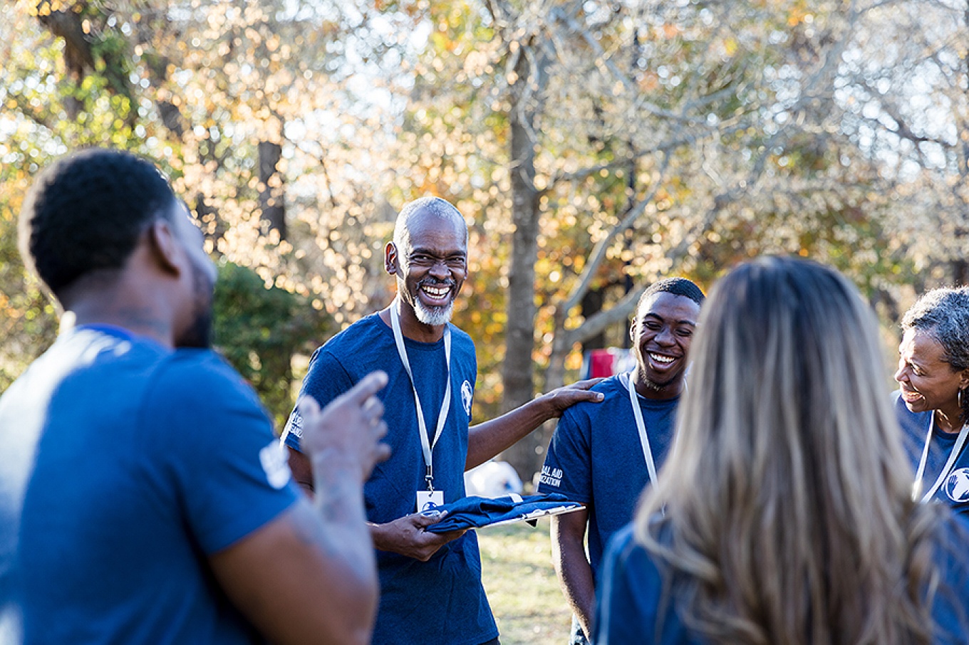 An older man working with a community group. 