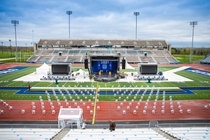 Zoom image: The stadium stage and graduate seating on the track ahead of the Jacobs School commencement on April 30. 