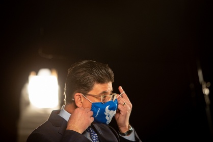Zoom image: Dan Sperrazza, an alumnus and guest speaker for the Honors College ceremony, removes his mask as he prepares to record his remarks in the Screen Room on April 20. 