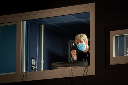 Zoom image: Regina Ticco offers some advice to a speaker from the sound booth in the Screen Room in the Center for the Arts on April 20. 