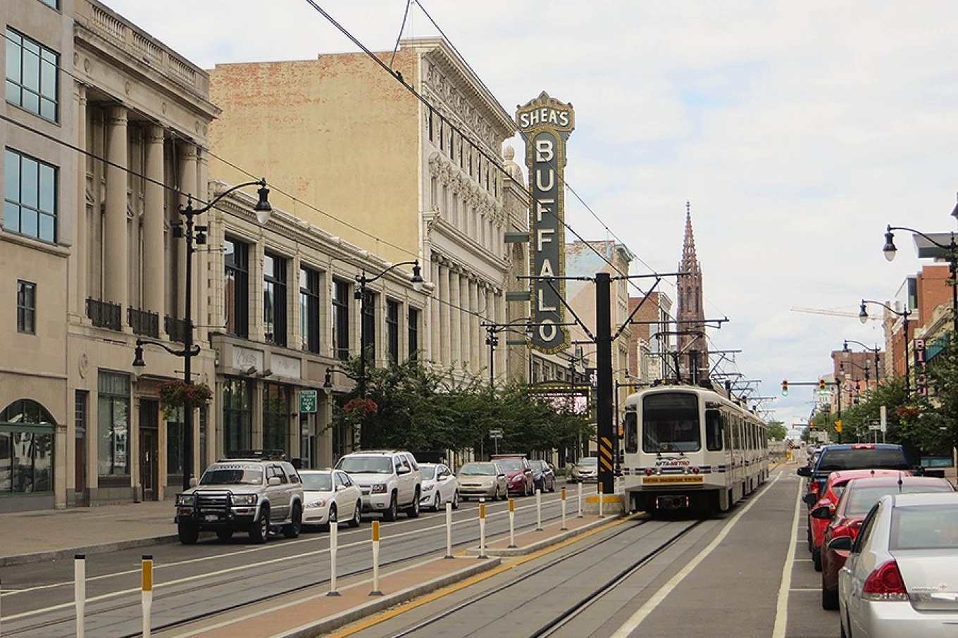 Zoom image: A Metro Rail train runs down Main Street past Shea's Buffalo theater. David Wilson//Wikimedia, CC BY 