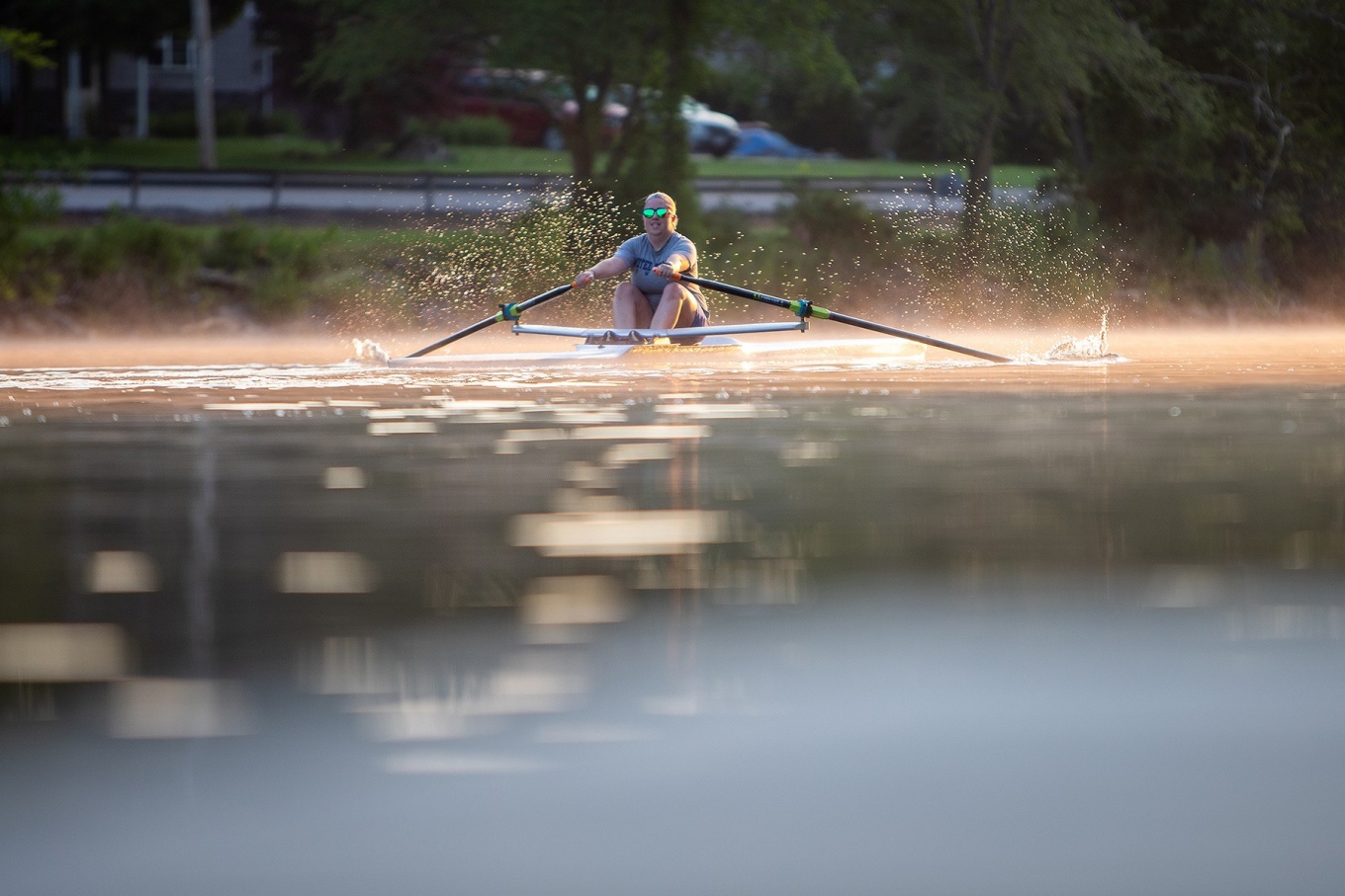 Zoom image: Katie Barnum pulls her 27-foot scull through on Tonawanda Creek. 