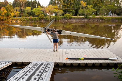 Zoom image: Barnum carries her boat about 100 yards from the boathouse to the creek. She has rowed for 23 years. Photo: Meredith Forrest Kulwicki 
