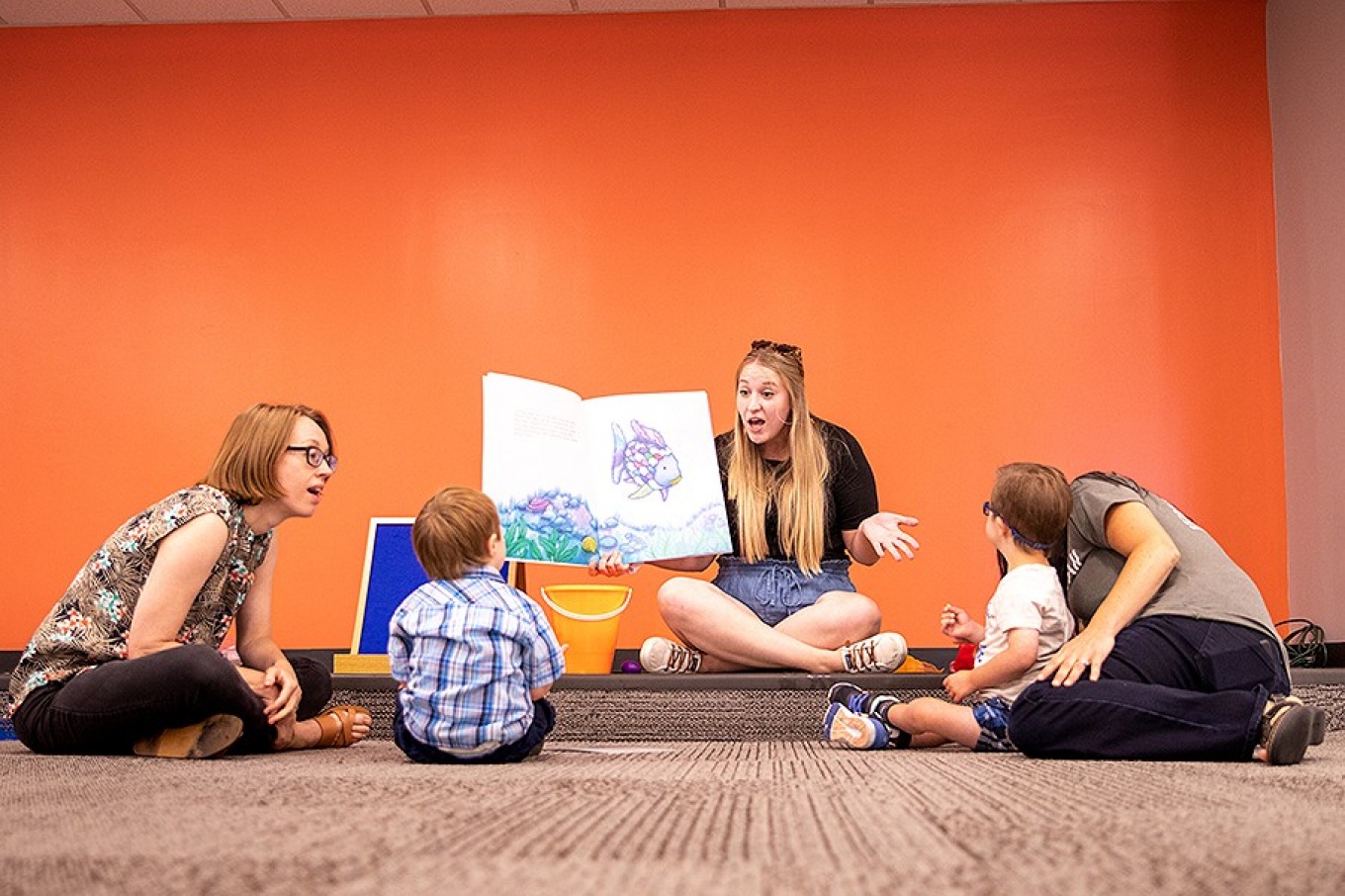 Zoom image: GSE professor Claire Cameron (left) and doctoral student Krystal Starke (center) work with students at Gigi's Playhouse. At right, Emily Mondschein (gray shirt), executive director of GiGi’s Playhouse Buffalo, talks to a student. Photo: Meredith Forrest Kulwicki 