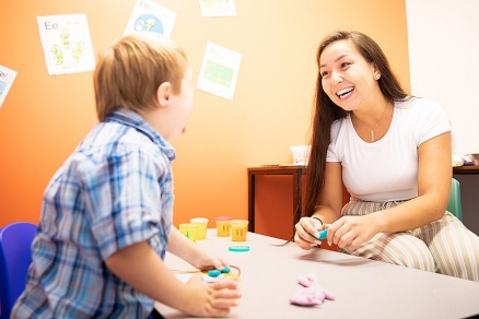 Zoom image: UB master's student Olivia Holmwood works with a student at Gigi's Playhouse. Photo: Meredith Forrest Kulwicki 
