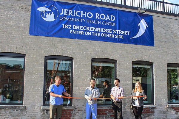 Zoom image: Cutting the ribbon at the grand opening are, from left, Myron Glick, MD, founder and CEO of Jericho Road; Naung Mon (Norman) Maran, MD, James Stoltzfus, MD, a physician with Jericho Road; Jennifer Corliss, director of UB's family medicine residency program. 