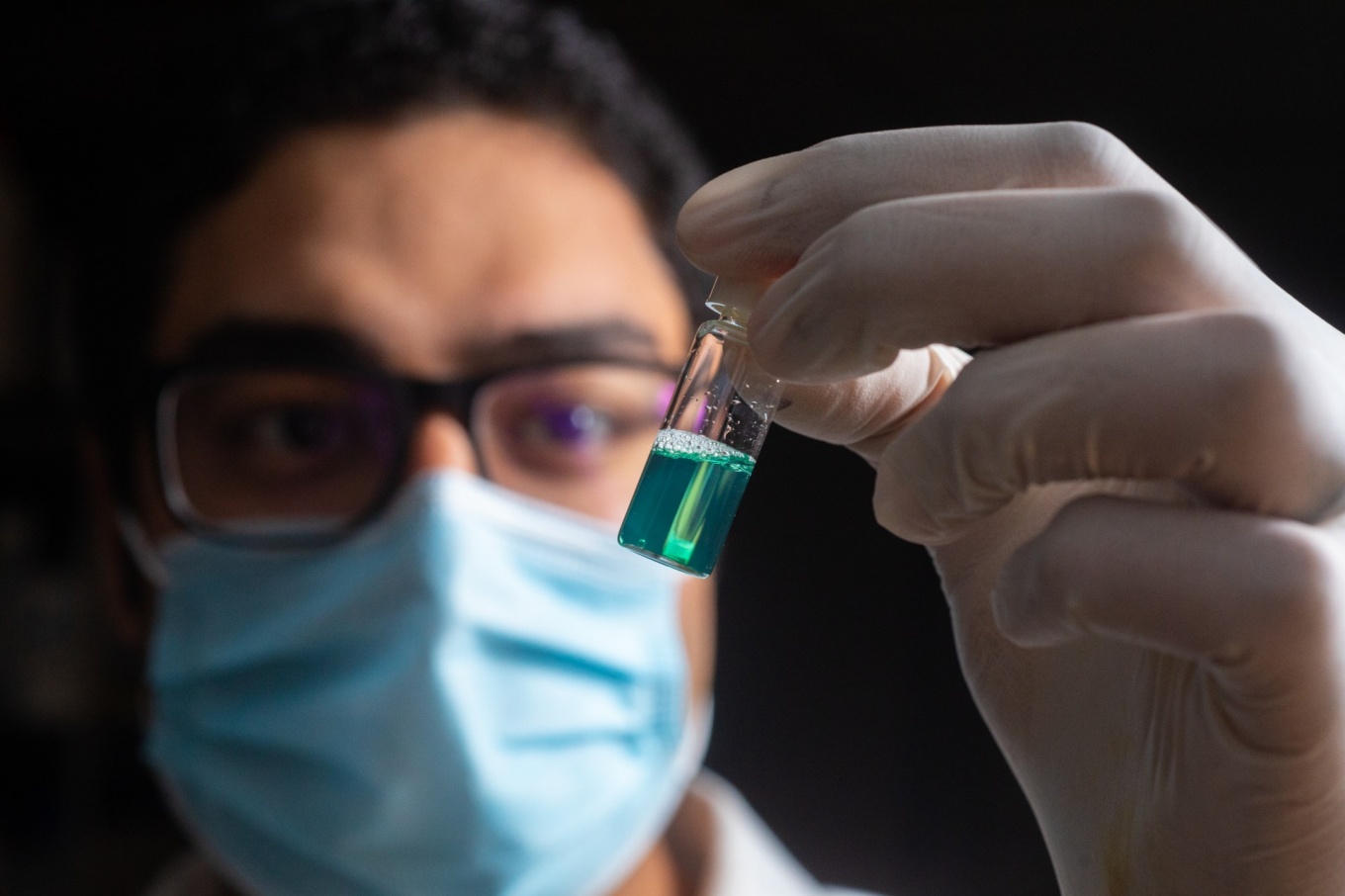 Moustafa Mabrouk holding a small vial.