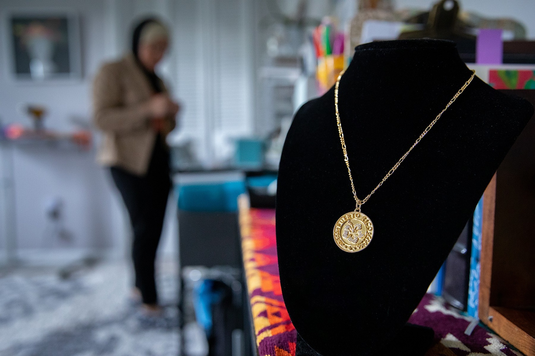 Zoom image: The Heriberta necklace, a piece designed by Renad Aref with inspiration from her heritage and generations of women in her family, is displayed in her workspace for La Reina Charm. 