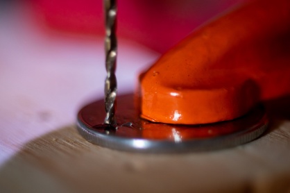 Zoom image: Aref uses a 1/16th drill bit for most of her coin jewelry. She says it works well to create the hole needed for the piece but doesn’t take away from the coin design. 