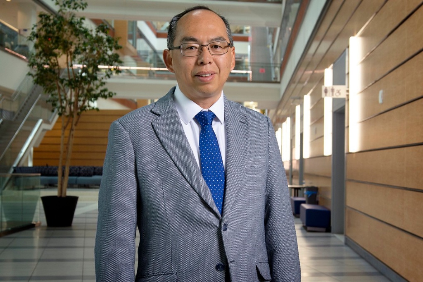 Jian Feng in lobby of Jacobs School. 