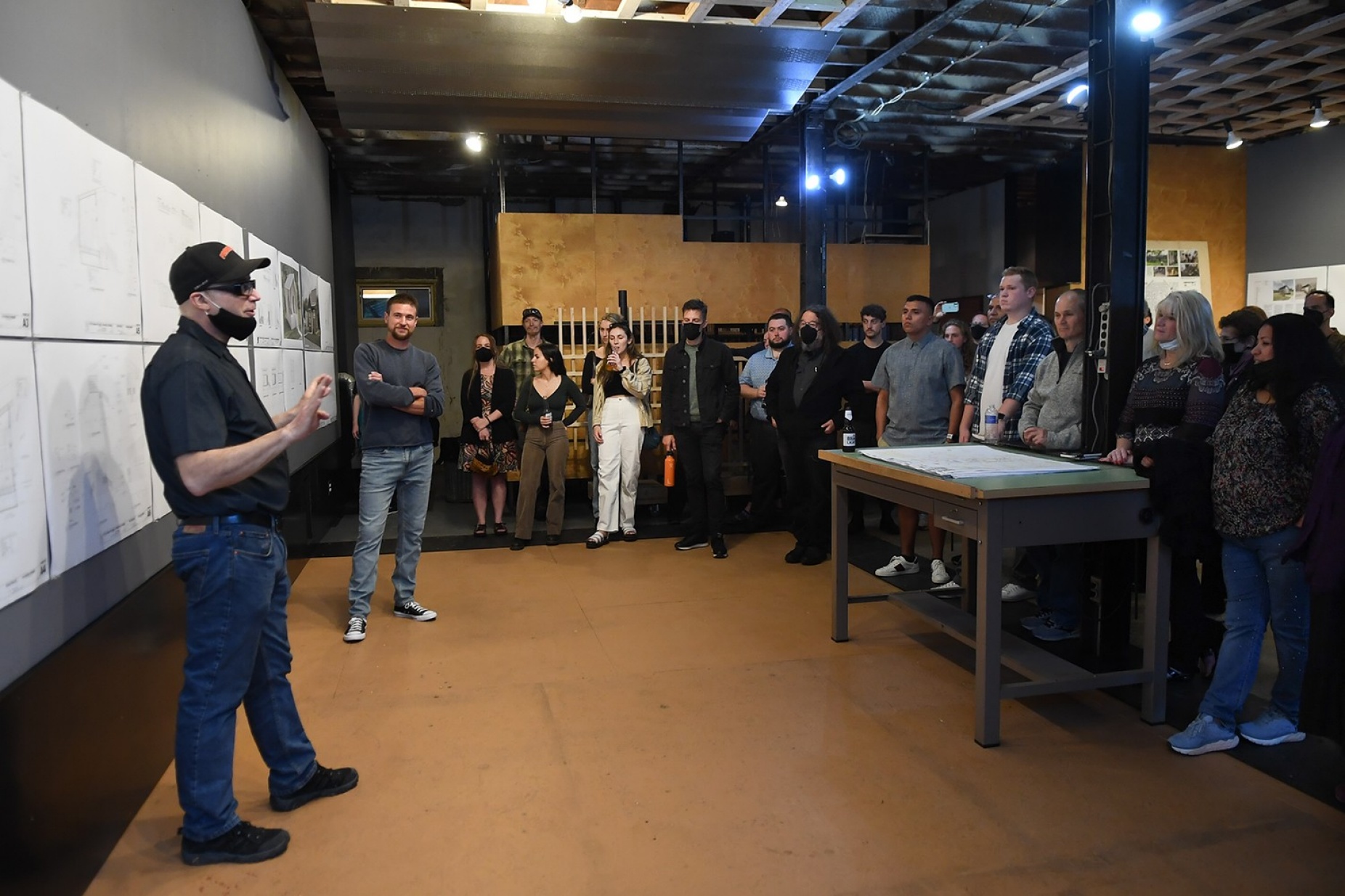 Zoom image: Brad Wales (foreground), UB clinical assistant professor of architecture, and Andrew Lunetta, executive director of A Tiny Home for Good, address class members during final presentations in May. Photo: Nancy J. Parisi 