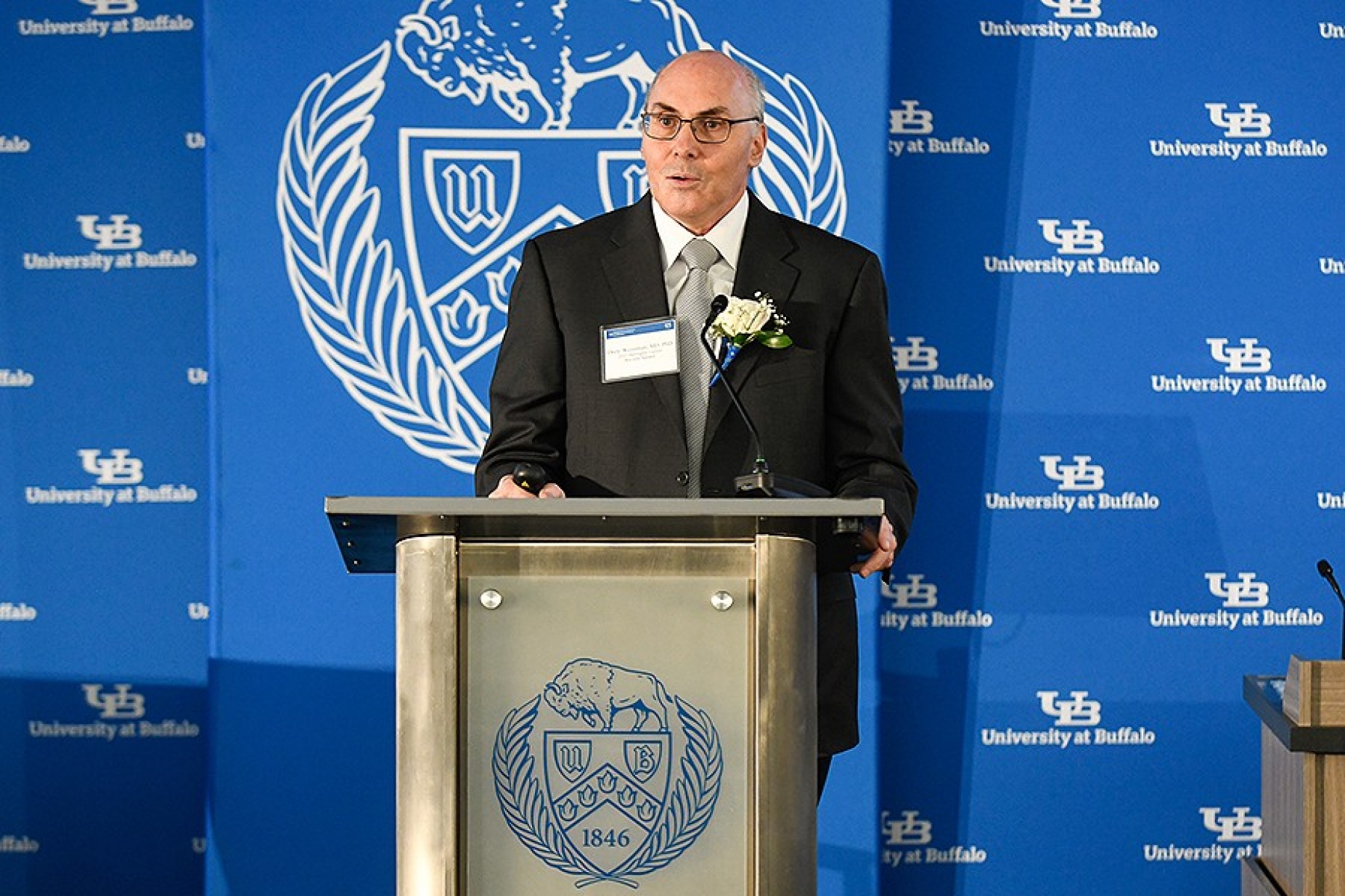 Drew Weissman, speaking at a podium. 