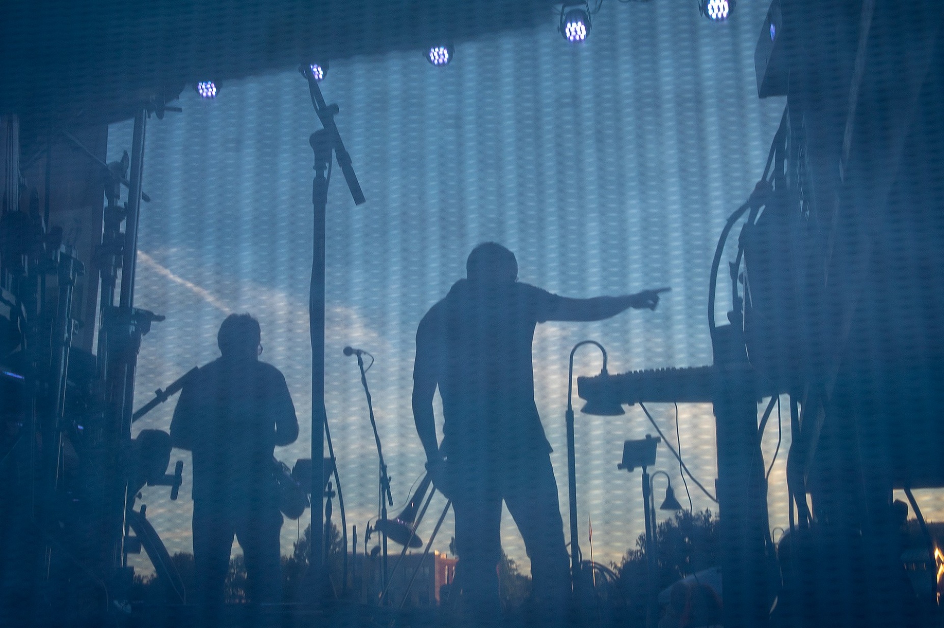 Zoom image: A view from behind stage shows Mauck (center) enjoying the energy from the crowd. He likes performing, saying music is meant to be shared. 